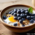 수명 연장에 좋은 식품 - A vibrant breakfast bowl featuring fresh blueberries, creamy natural yogurt, and a generous sprinkle...